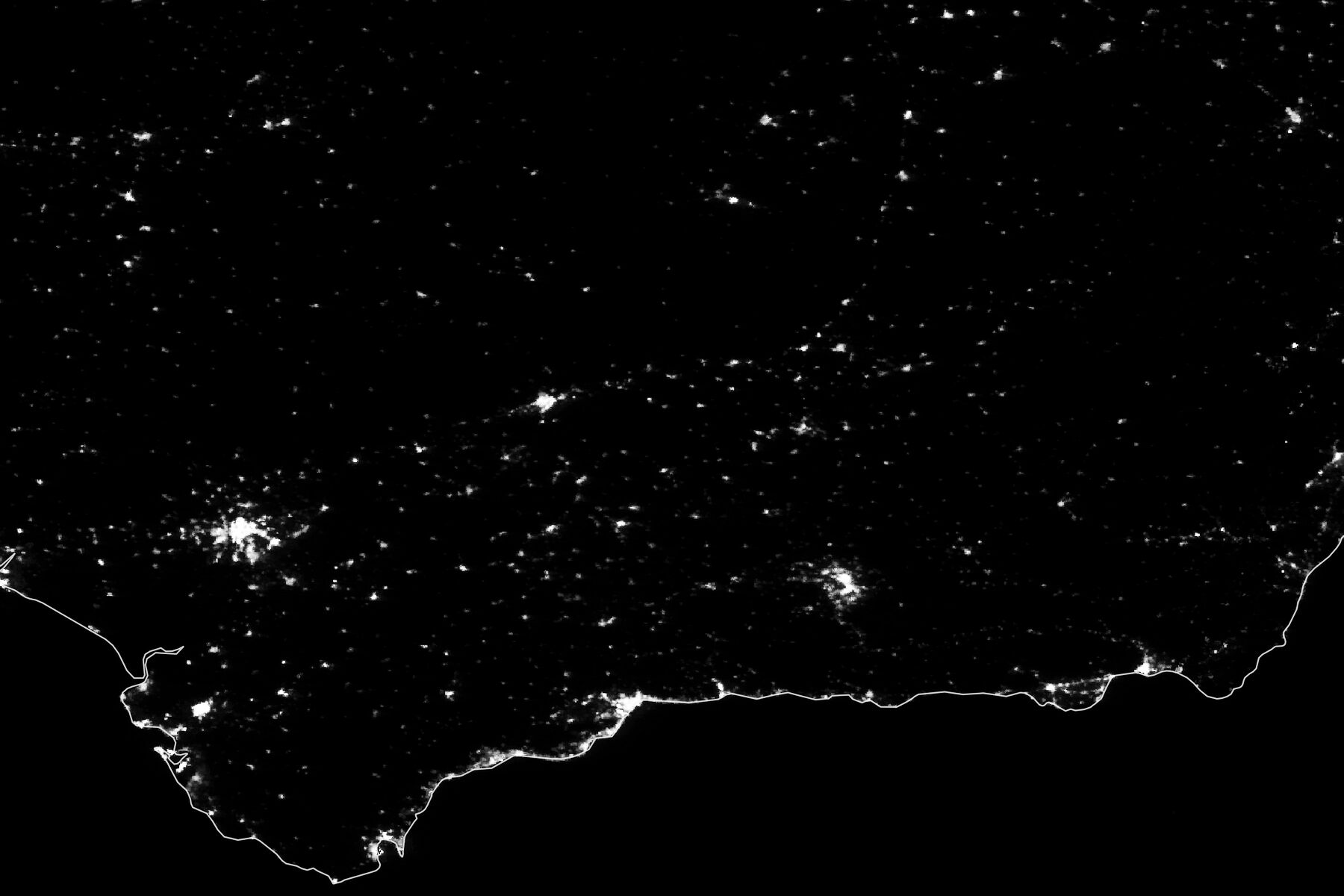 A nighttime lights map of southern Spain during a regional power blackout: scattered white settlement lights on a black field, with the south coast drawn as a thin pale line